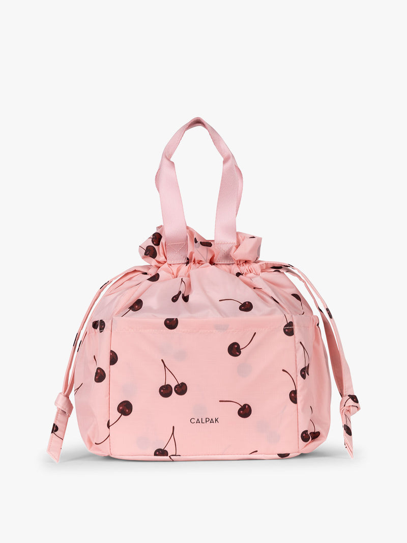 CALPAK Insulated Lunch Bag in Blossom Cherry in pink with cherry print with drawstring