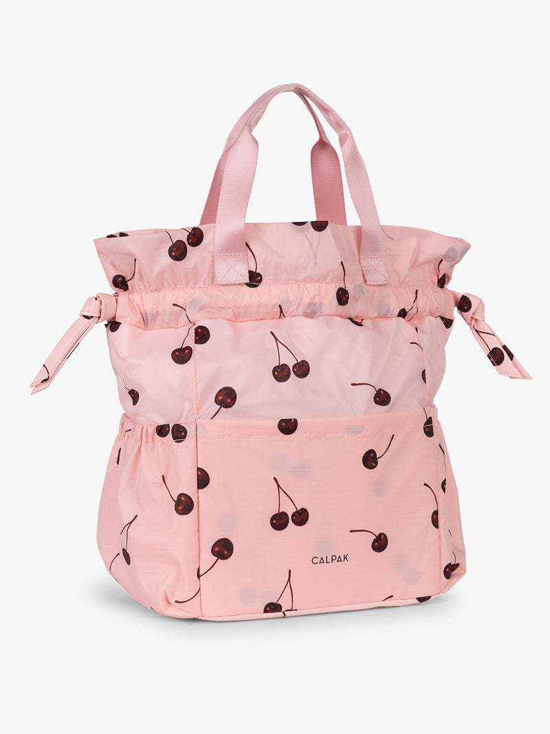CALPAK Insulated Lunch Bag in Blossom Cherry in pink with cherry print with drawstring showing full height