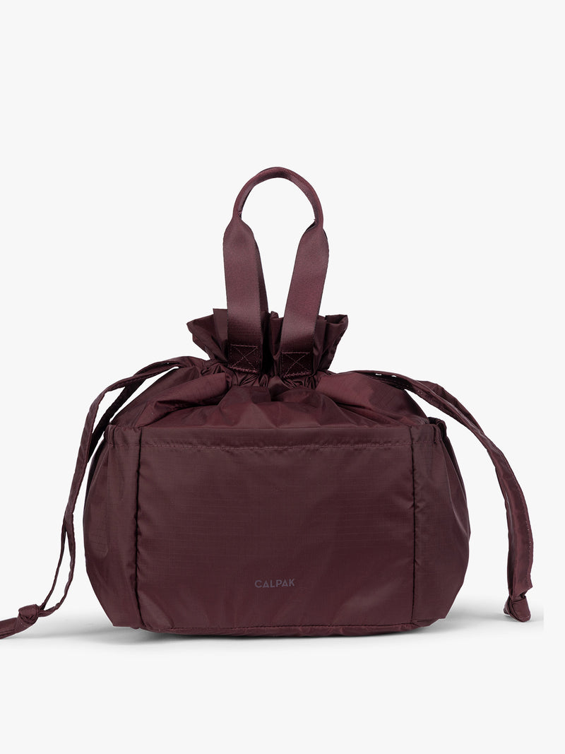 Burgundy Dark Cherry CALPAK Insulated Lunch Bag with top handles, shown against a plain white background