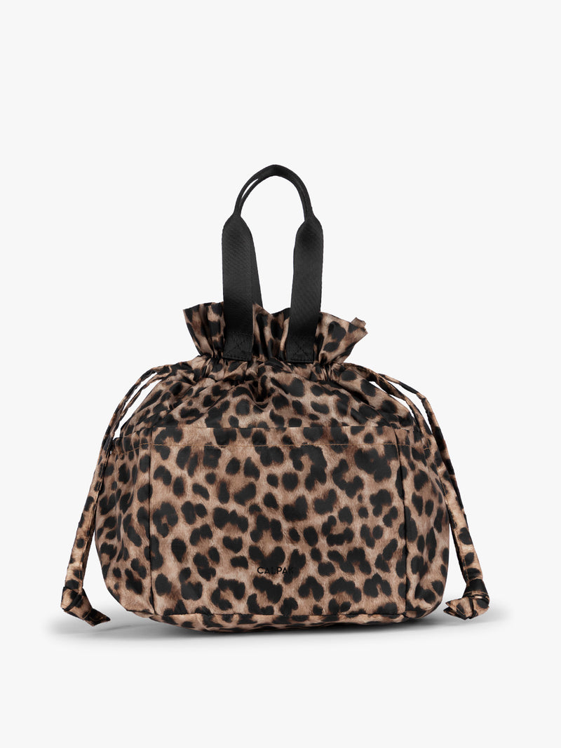 Leopard animal print of the CALPAK Insulated Lunch Bag with top handles, shown against a plain white background