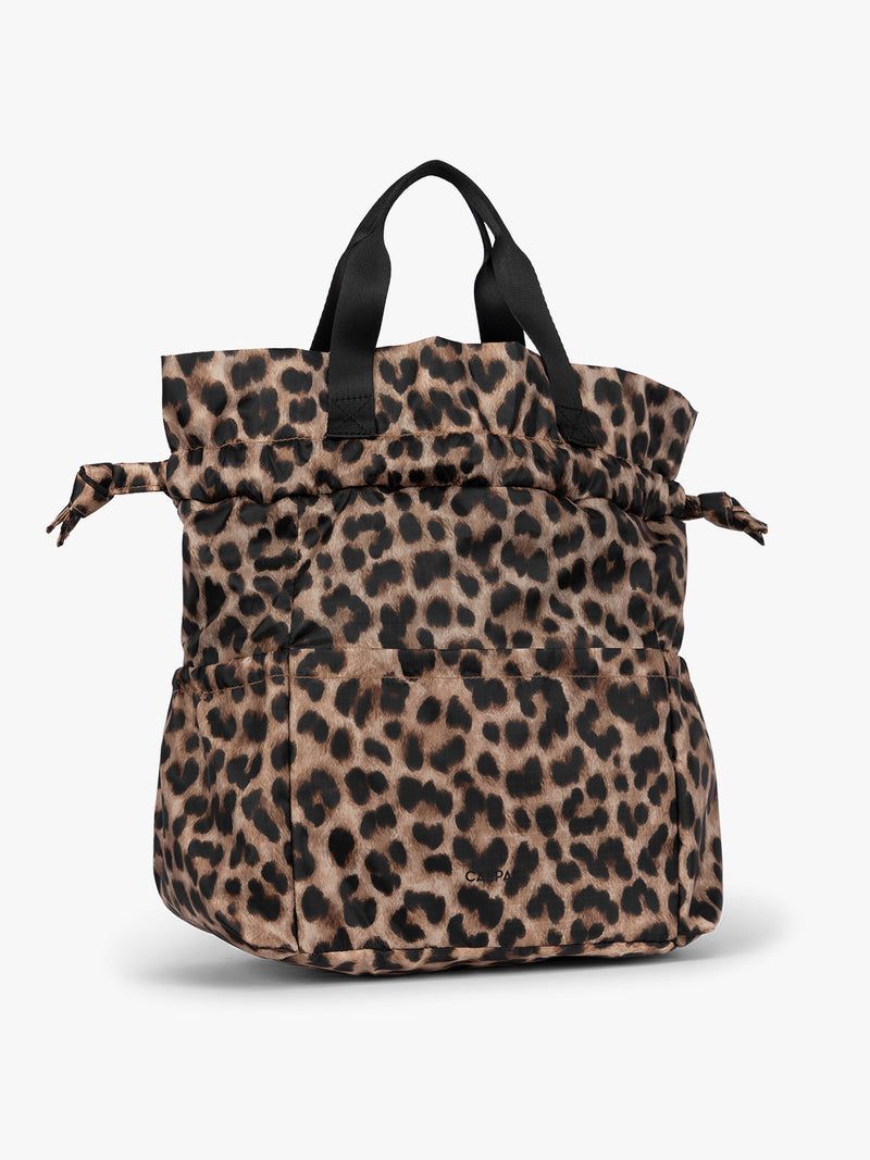 Leopard print CALPAK Insulated Lunch Bag with top handles, featuring an expandable function shown against a plain white background