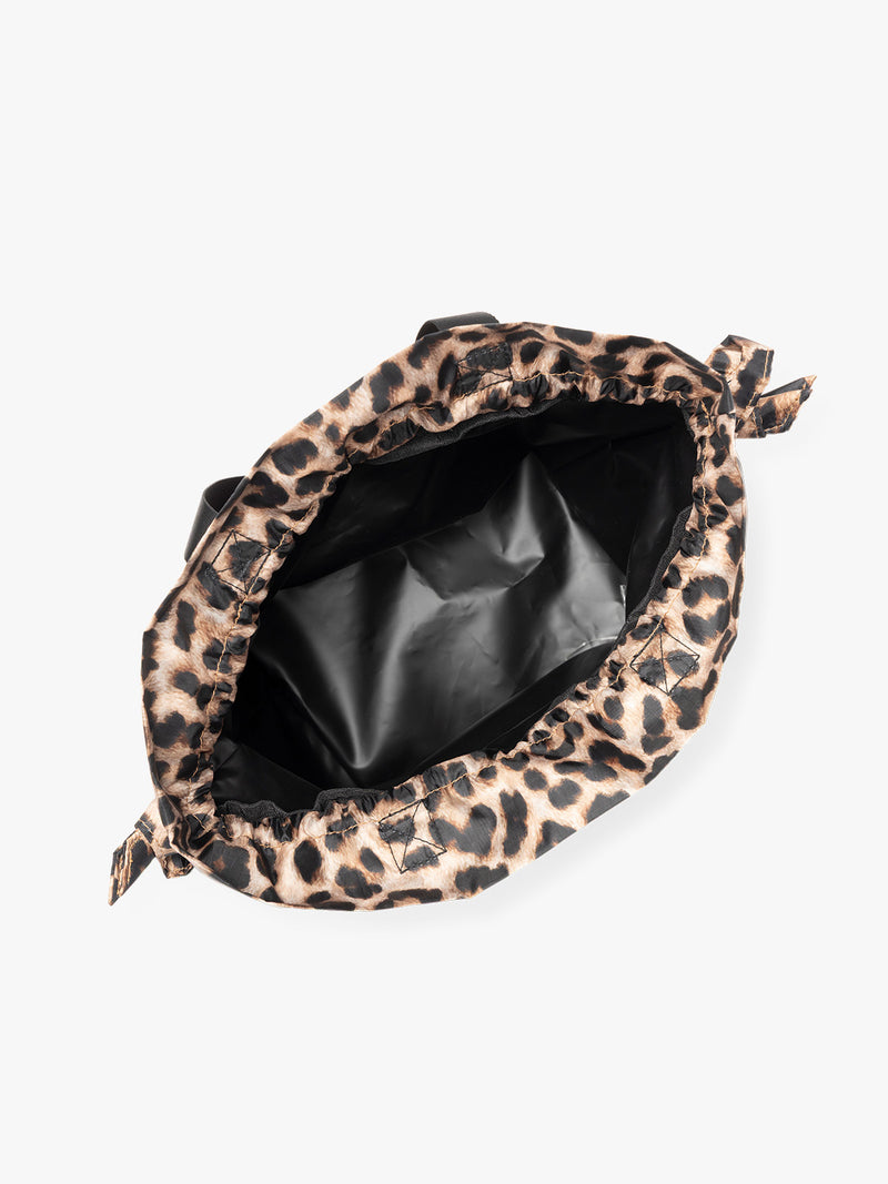 Opened animal print Leopard CALPAK Insulated Lunch Bag with top handles, featuring a white interior lining shown against a plain white background