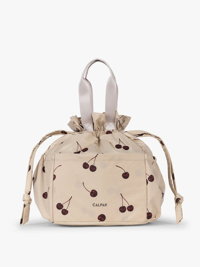 CALPAK Insulated Lunch Bag in Oatmeal Cherry in tan with cherry print with drawstring; ALB2001-OATMEAL-CHERRY view 1
