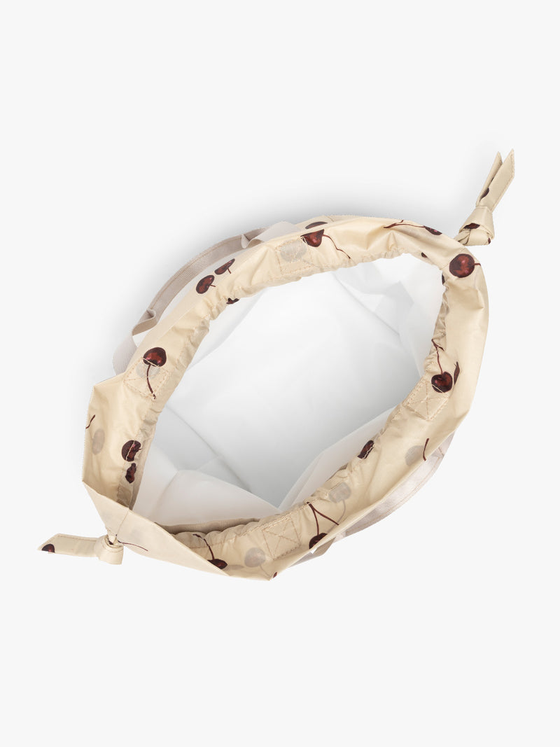 CALPAK Insulated Lunch Bag in Oatmeal Cherry in tan with cherry print with drawstring opened
