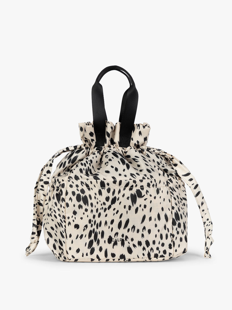 White and black Snow Leopard animal print of the CALPAK Insulated Lunch Bag with top handles, shown against a plain white background