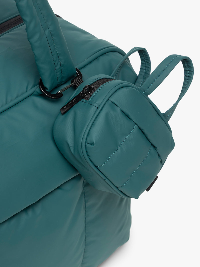 CALPAK Luka Duffel Zip Bag Charm in dark green Kale attached to a bag