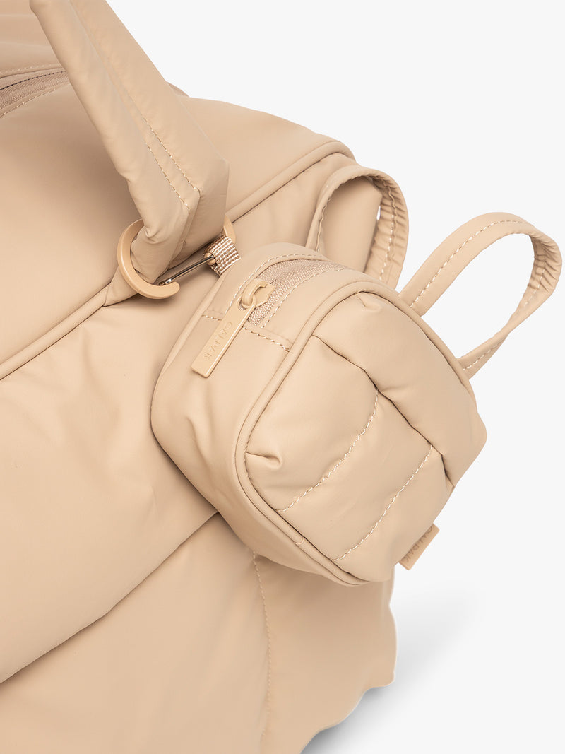 CALPAK Luka Duffel Zip Bag Charm in beige Latte attached to bag