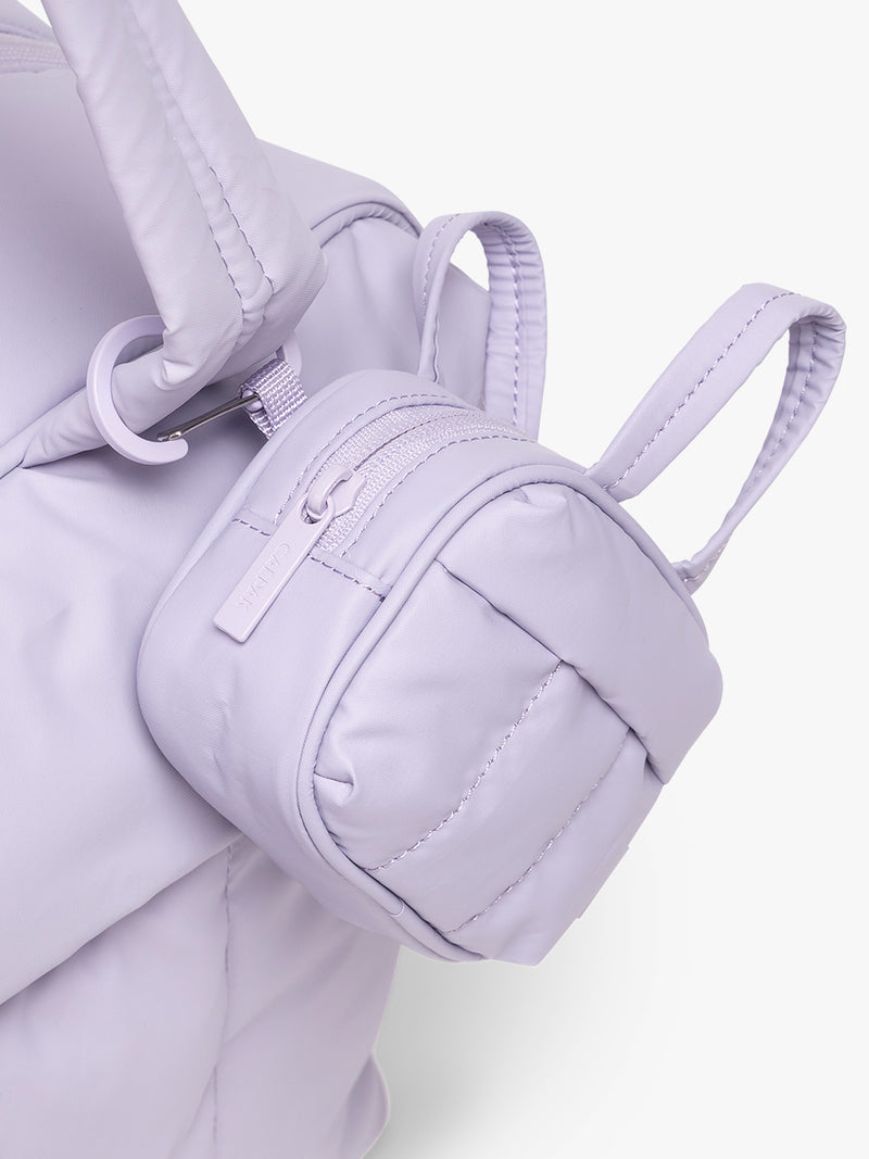 CALPAK Luka Duffel Zip Bag Charm in lavender Orchid attached to bag