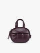 A deep burgundy Dark Cherry vegan leather top-handle CALPAK Luka Zip Bag Charm with a zippered front pocket and a small side strap, shown against a plain white background; ALK2501-DARK-CHERRY-PU
