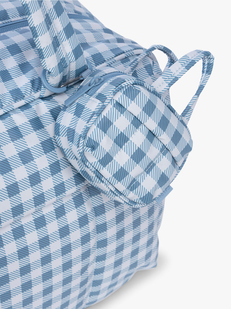 CALPAK Luka Duffel Zip Bag Charm in white and blue gingham print in French Blue Gingham clipped on a bag