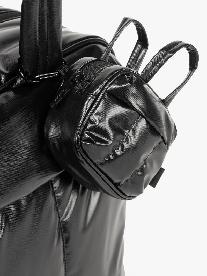 CALPAK Luka Duffel Key Pouch in Glazed Black clipped on a bag