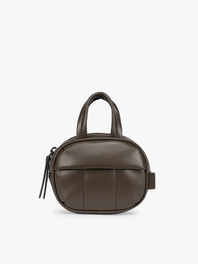 A dark brown Mushroom vegan leather top-handle CALPAK Luka Zip Bag Charm with a zippered front pocket and a small side strap, shown against a plain white background; ALK2501-MUSHROOM-PU view 1