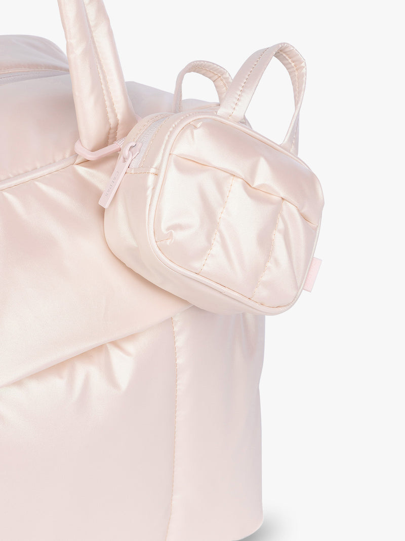 CALPAK Luka Duffel Zip Bag Charm in light pink shiny Pearlescent clipped on bag