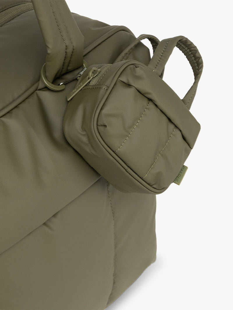 Luka Duffel Key Pouch in dark green Pine clipped on bag