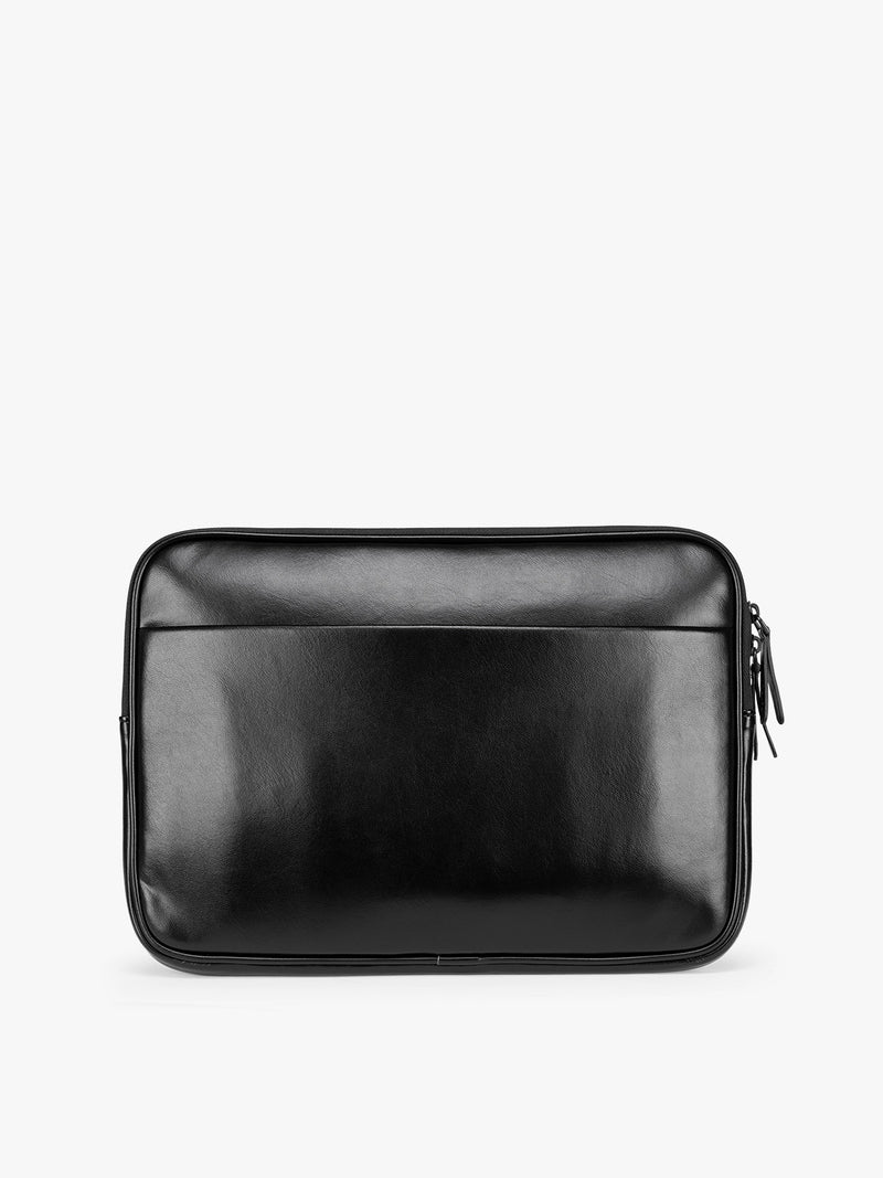 Back of a black vegan leather CALPAK Luka 14in Laptop Sleeve with a zippered top and a front pocket, shown against a plain white background