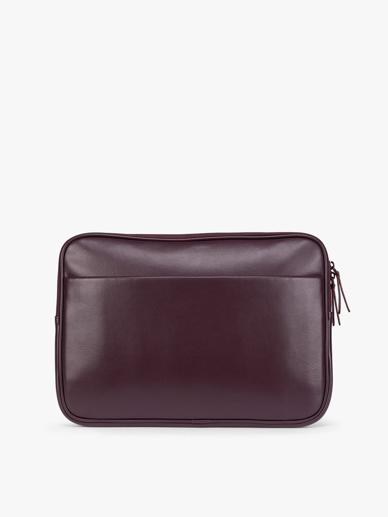 Backside of a deep burgundy Dark Cherry vegan leather CALPAK Luka 14in Laptop Sleeve with a zippered top and a front pocket, shown against a plain white background