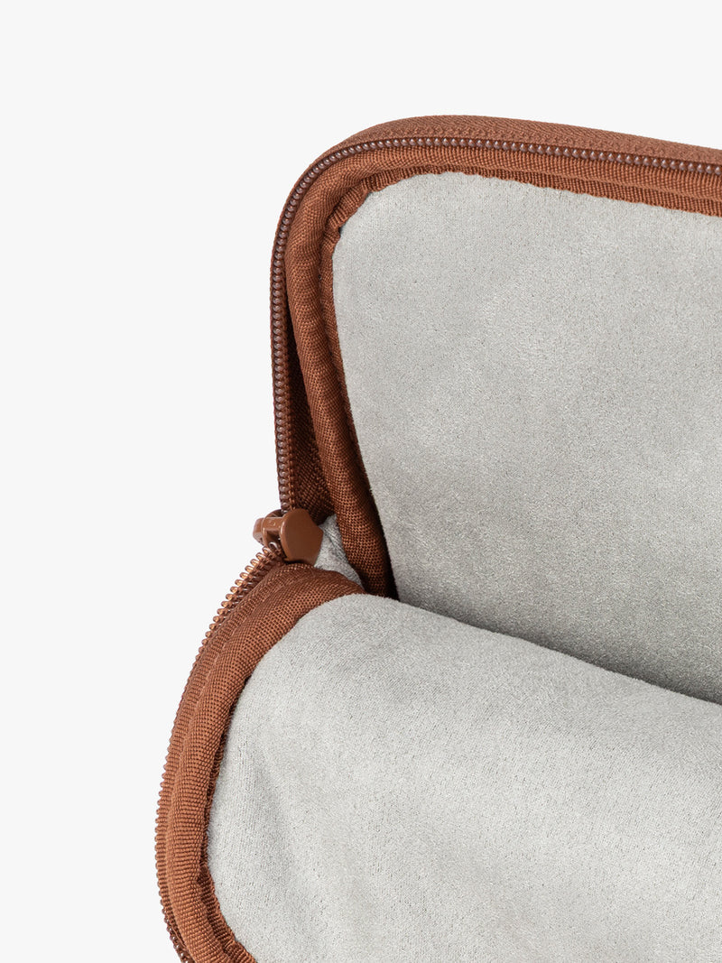 Interior of Light Honey Brown vegan leather CALPAK Luka 14in Laptop Sleeve with a zippered top and a front pocket, shown against a plain white background