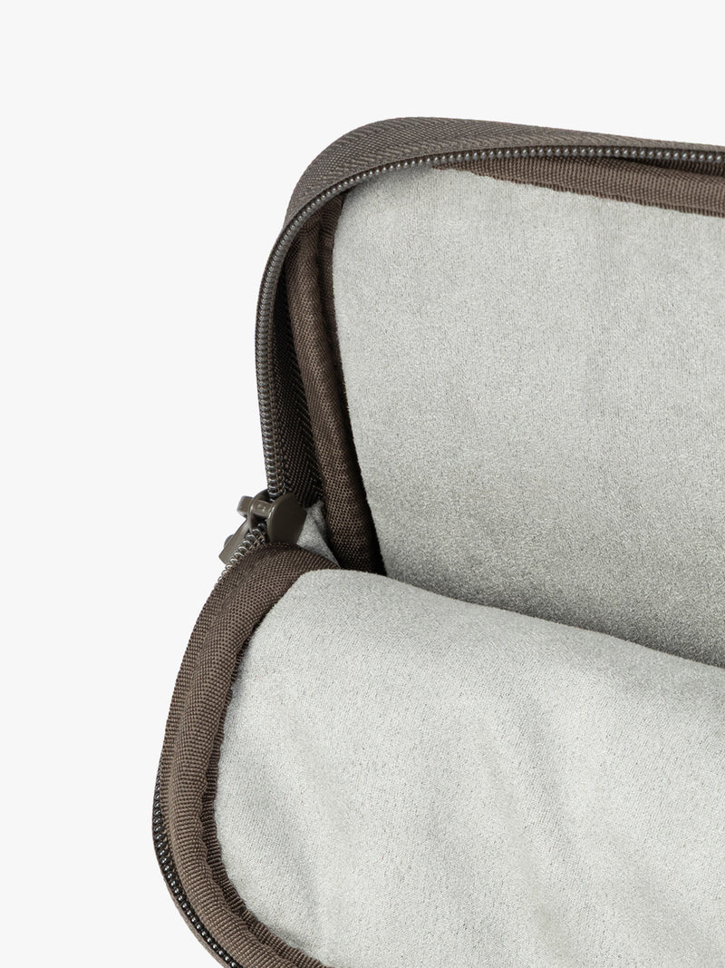 Opened interior of Dark brown Mushroom vegan leather CALPAK Luka 14in Laptop Sleeve with a zippered top and a front pocket, shown against a plain white background