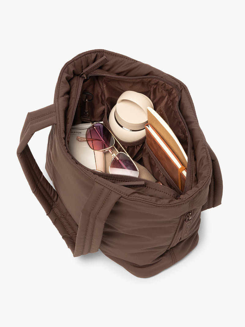 CALPAK Luka Mini Tote in brown monochrome Walnut interior view with notebooks, water bottle, and sunglasses
