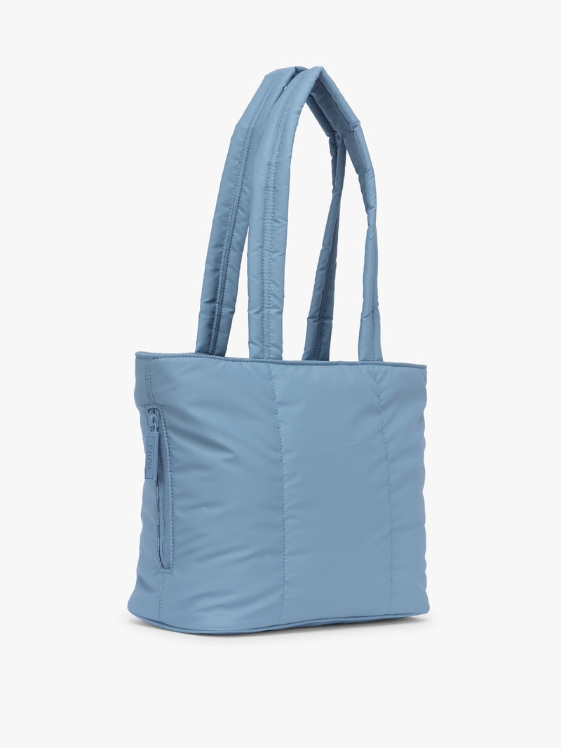 Side view of CALPAK Luka Mini Tote in light blue French Blue