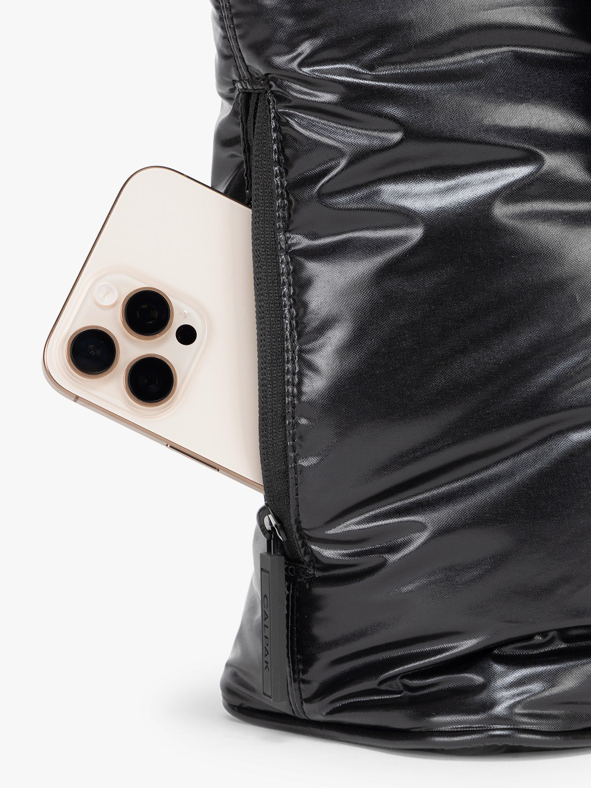 Side phone pocket of the CALPAK Luka Mini Tote in shiny Glazed Black on a white background; ALM2401-GLAZED-BLACK
