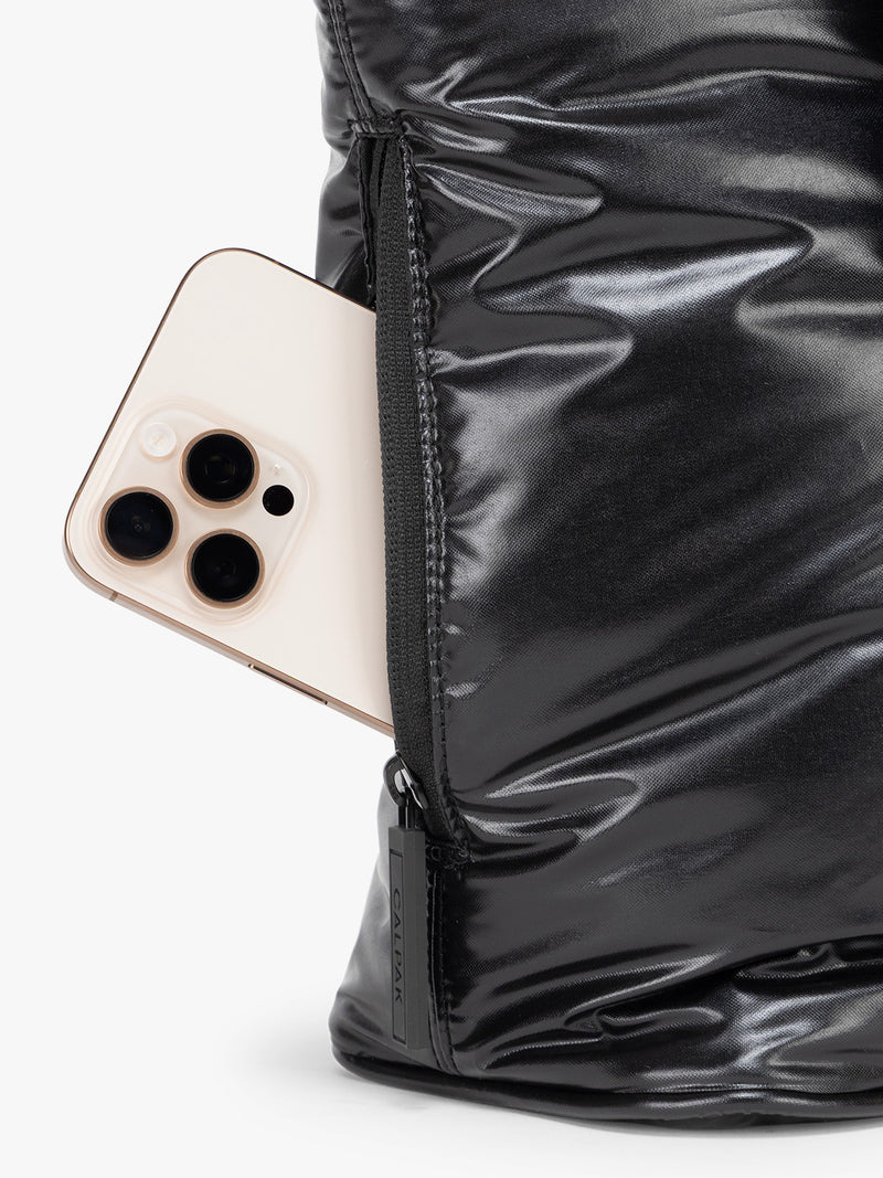 Side phone pocket of the CALPAK Luka Mini Tote in shiny Glazed Black on a white background