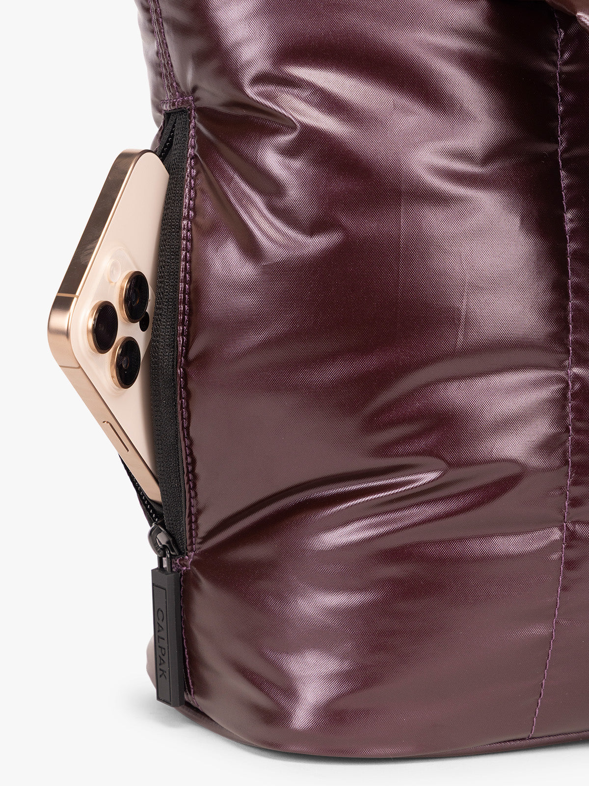 Side phone pocket view of CALPAK Luka Mini Tote in shiny maroon Glazed Dark Cherry on a white background; ALM2401-GLAZED-DARK-CHERRY