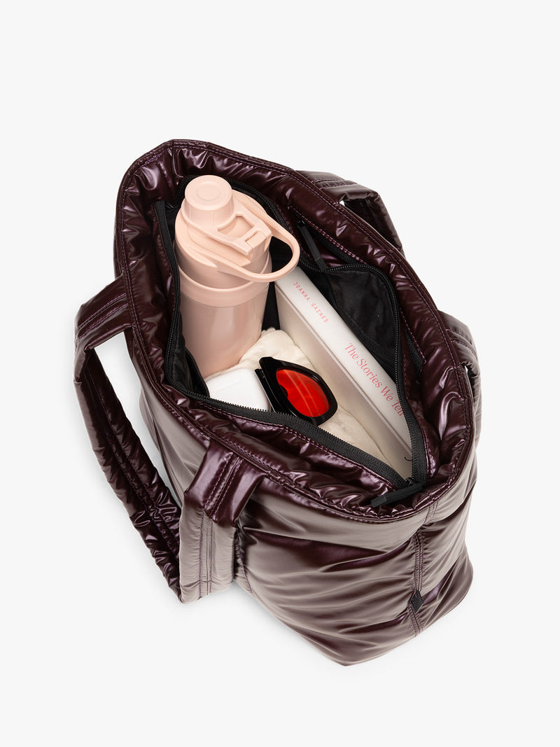 Opened view of CALPAK Luka Mini Tote in shiny maroon Glazed Dark Cherry on a white background