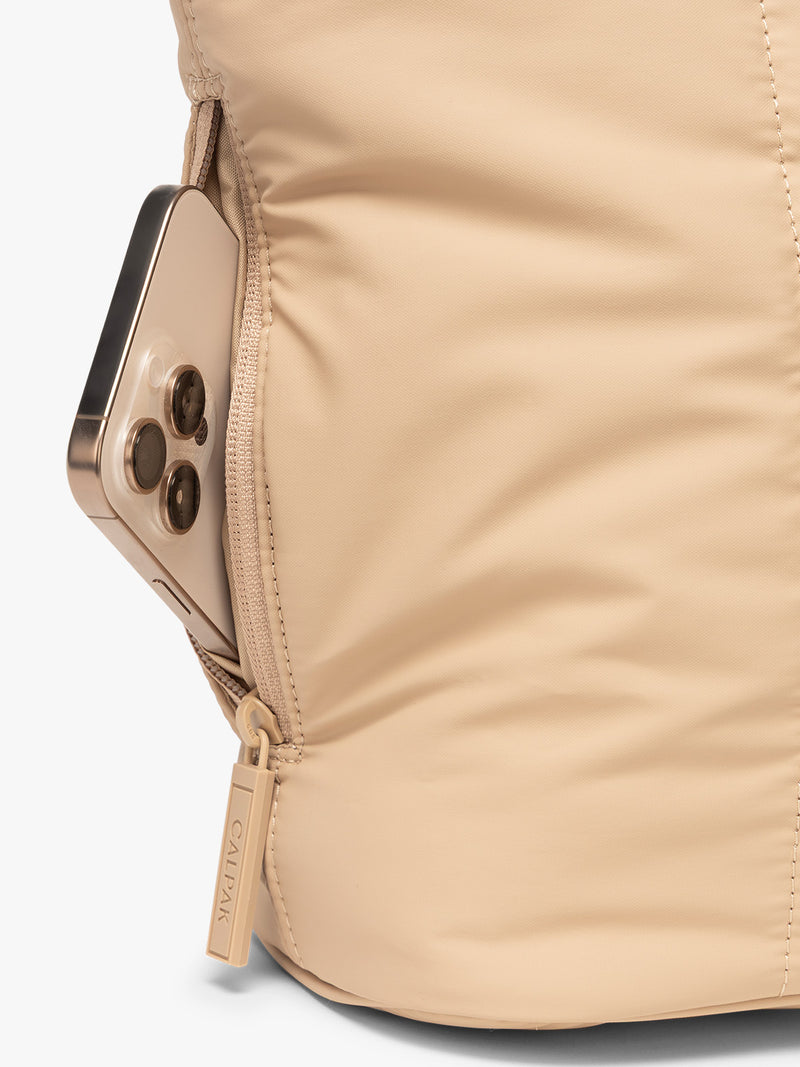 Side zip phone pocket of CALPAK Luka Mini Tote in beige Latte on a white background