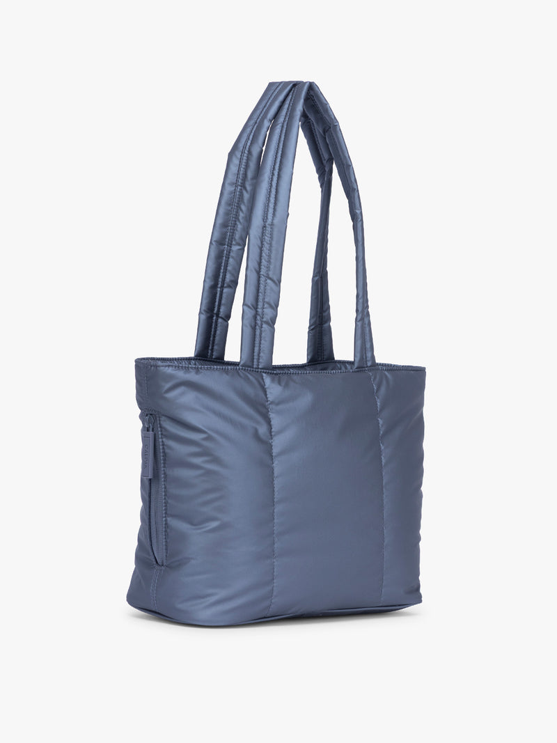 Side view of CALPAK Luka Mini Tote in metallic dark blue material in Metallic Indigo