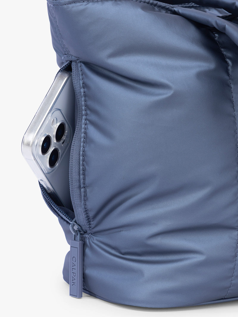 Side phone pocket with zipper of CALPAK Luka Mini Tote in metallic dark blue material in Metallic Indigo