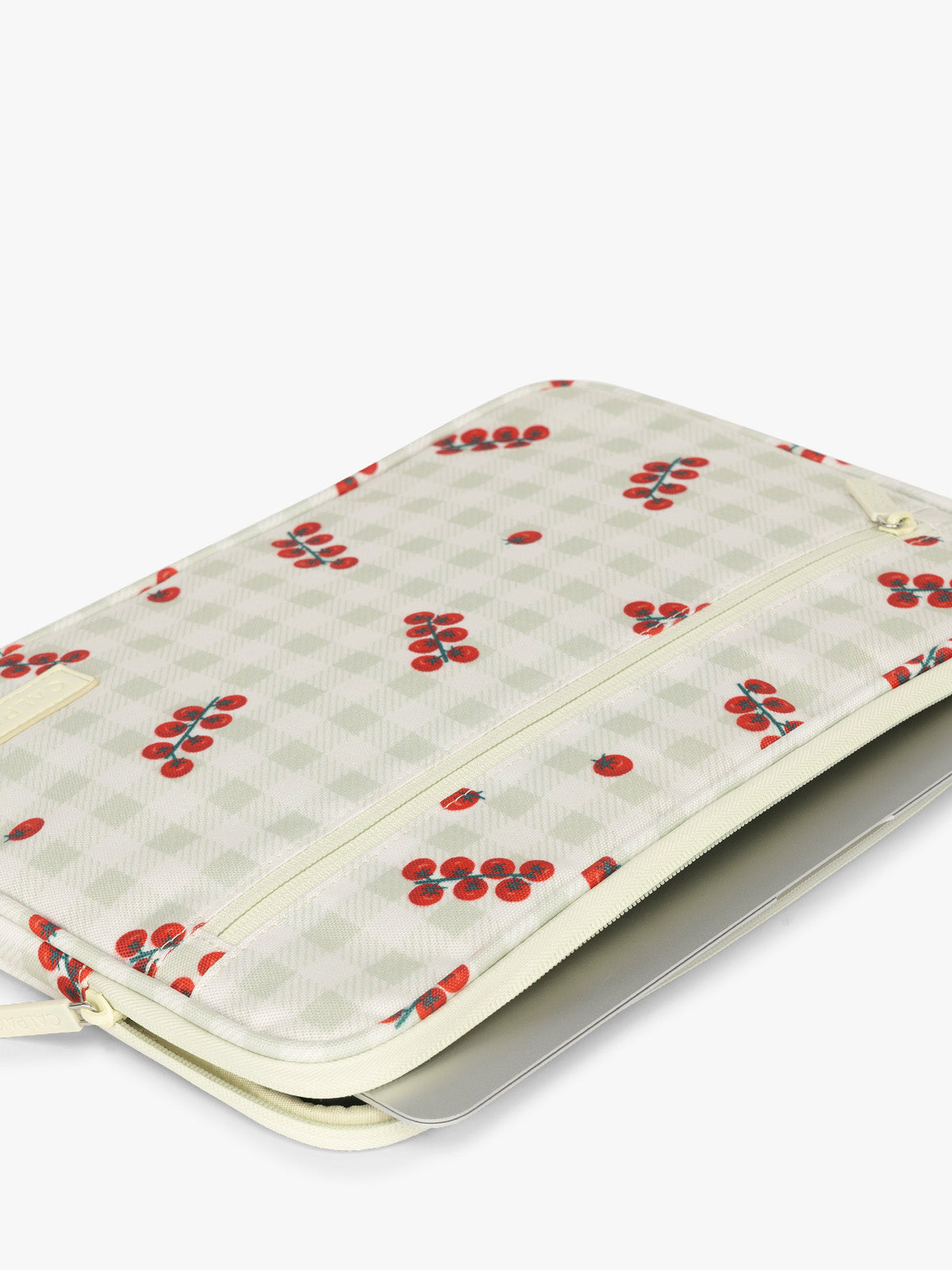 Laptop in the CALPAK 13"-14" Padded Laptop Sleeve in white and green gingham pattern with tomato print; ALP2213-CELADON-TOMATO-PICNIC