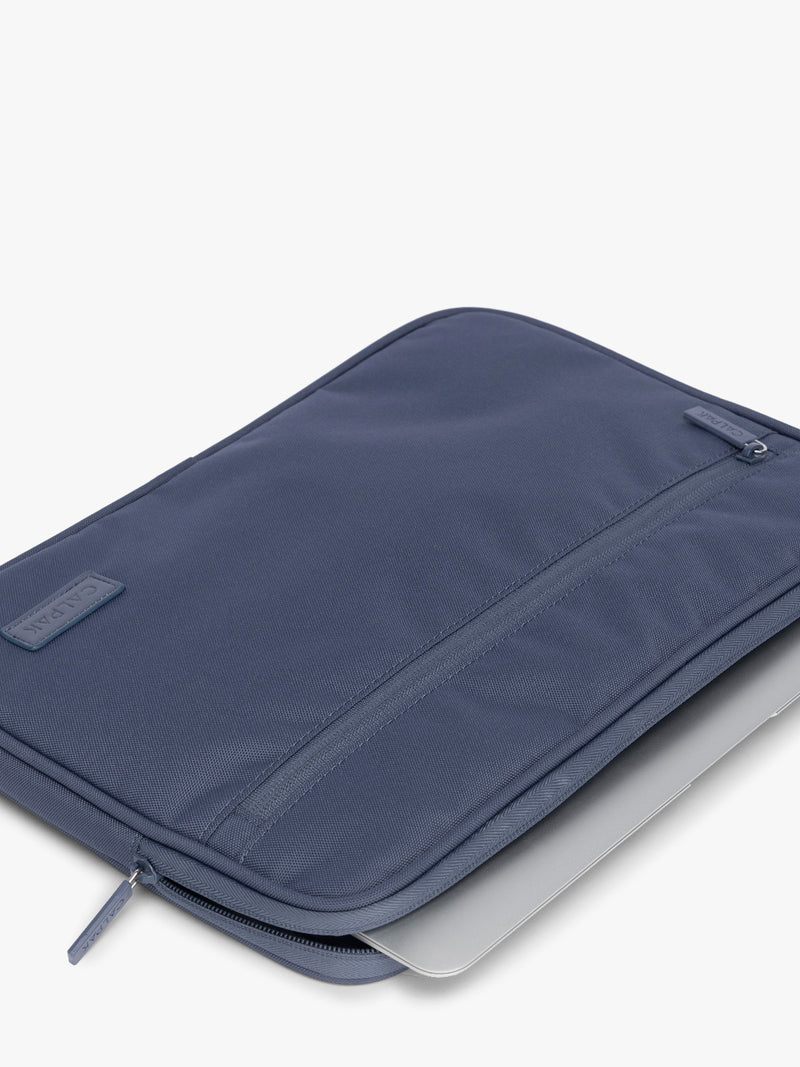 Flatlay with laptop inside of CALPAK Padded Laptop Sleeve 13" in dark blue Indigo
