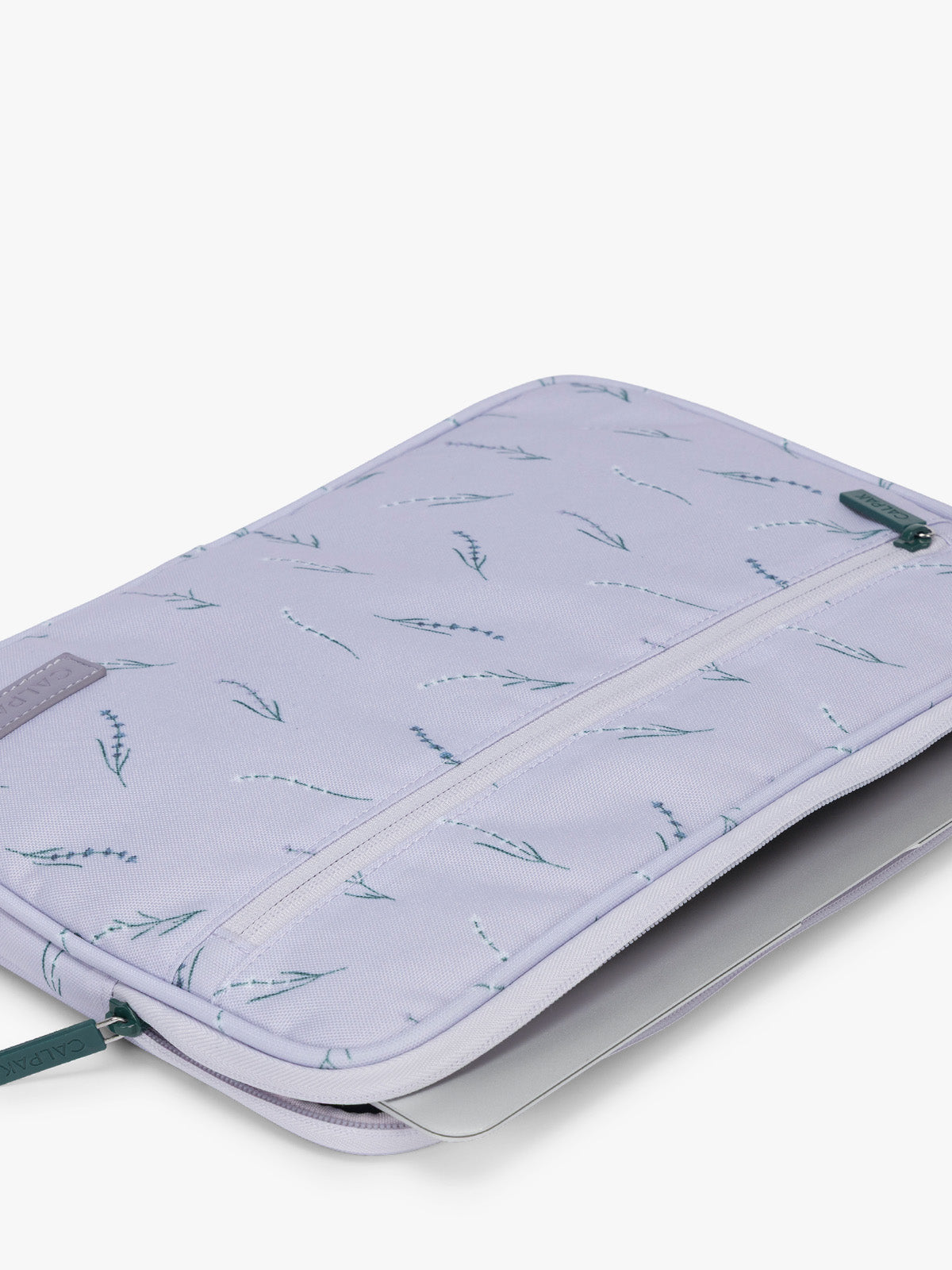 Flatlay with laptop in the CALPAK Padded Laptop Sleeve 13" in light purple with lavender print Lavender Bloom; ALP2213-LAVENDER-BLOOM