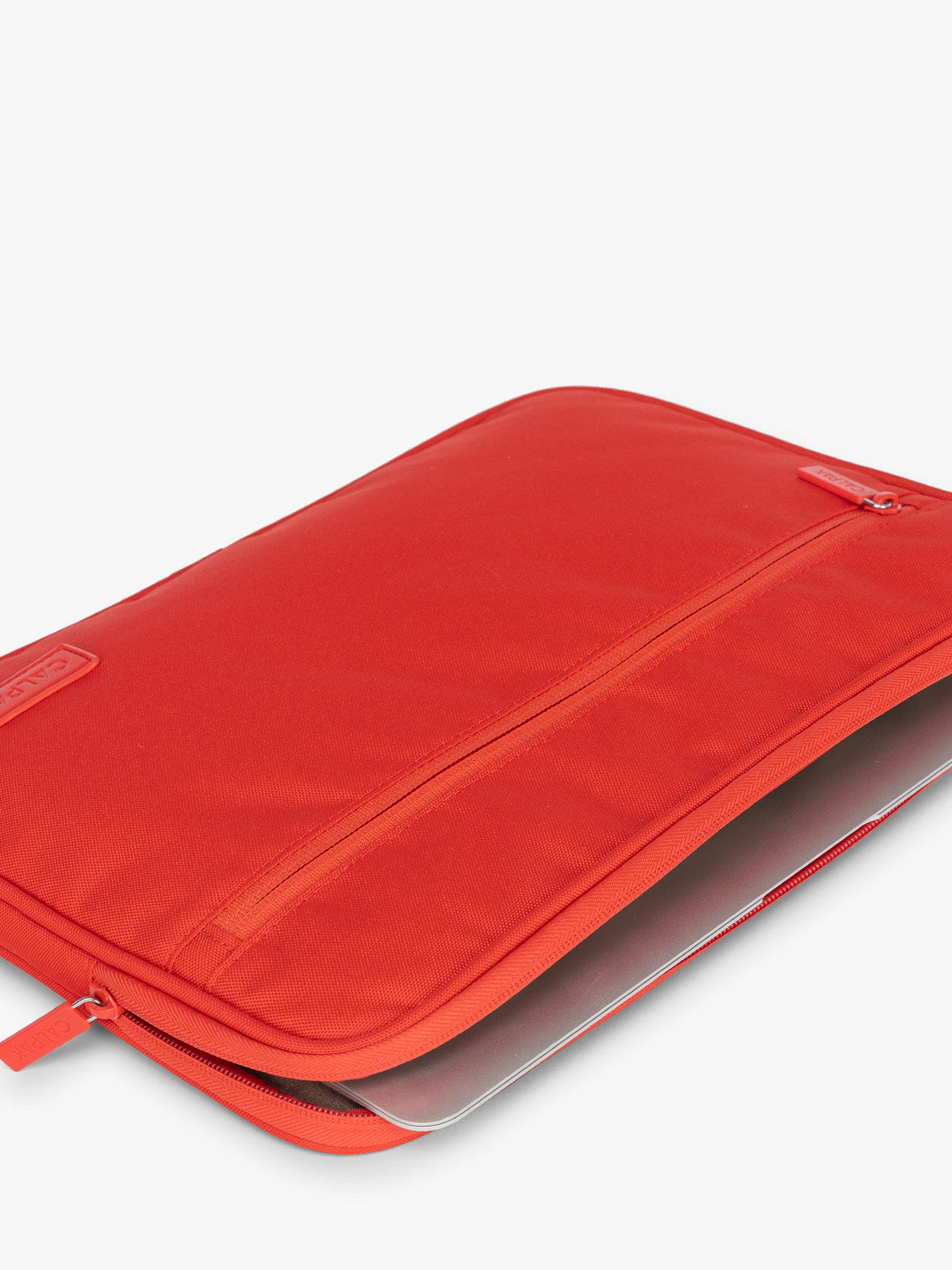 Laptop in the CALPAK Padded Laptop Sleeve 13-14" in red Tomato; ALP2213-TOMATO