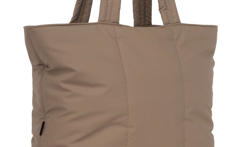 Close up image of plush material of the CALPAK Luka Expandable Tote in brown Chocolate