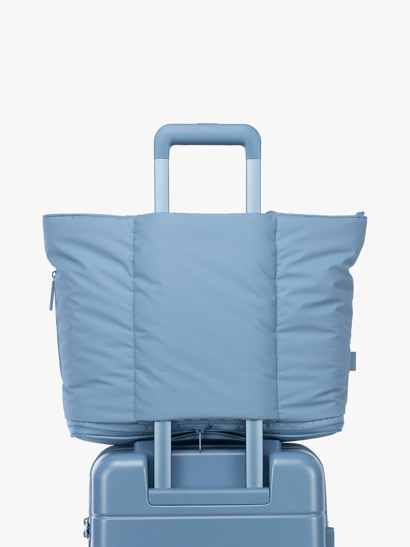Luggasge trollley sleeve of the CALPAK Luka Expandable Tote in light blue French Blue