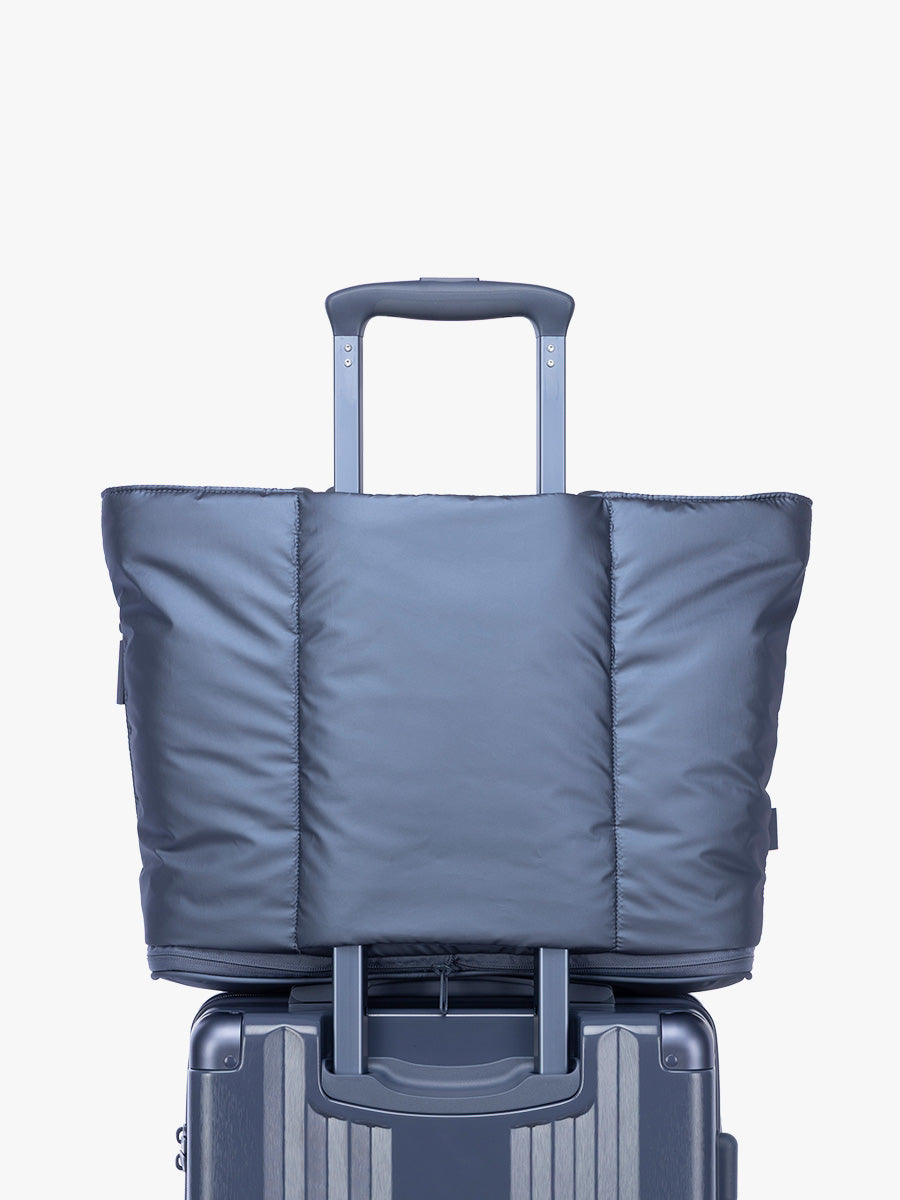 Luggage trolley sleeve of CALPAK Luka Expandable Tote in dark blue metallic material in Metallic Indigo; ALT2201-METALLIC-INDIGO