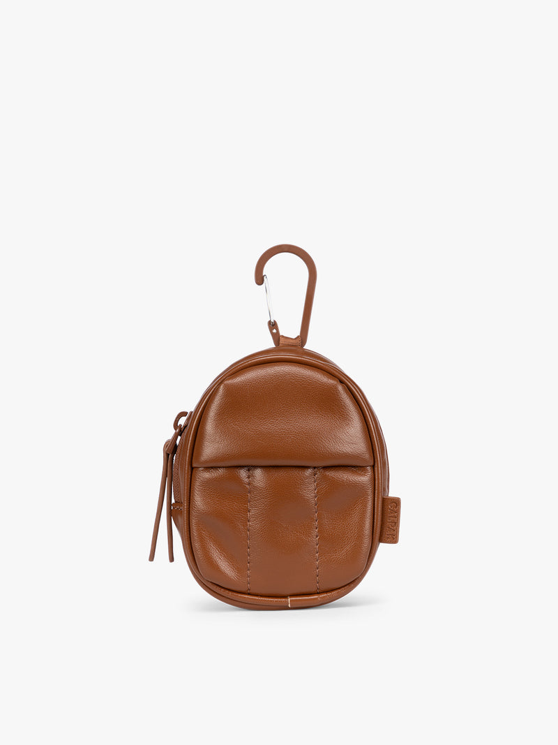 A small light Honey Brown CALPAK Luka Backpack Zip Bag Charm leather backpack keychain with a top carabiner and zipper pull, shown on a plain white background