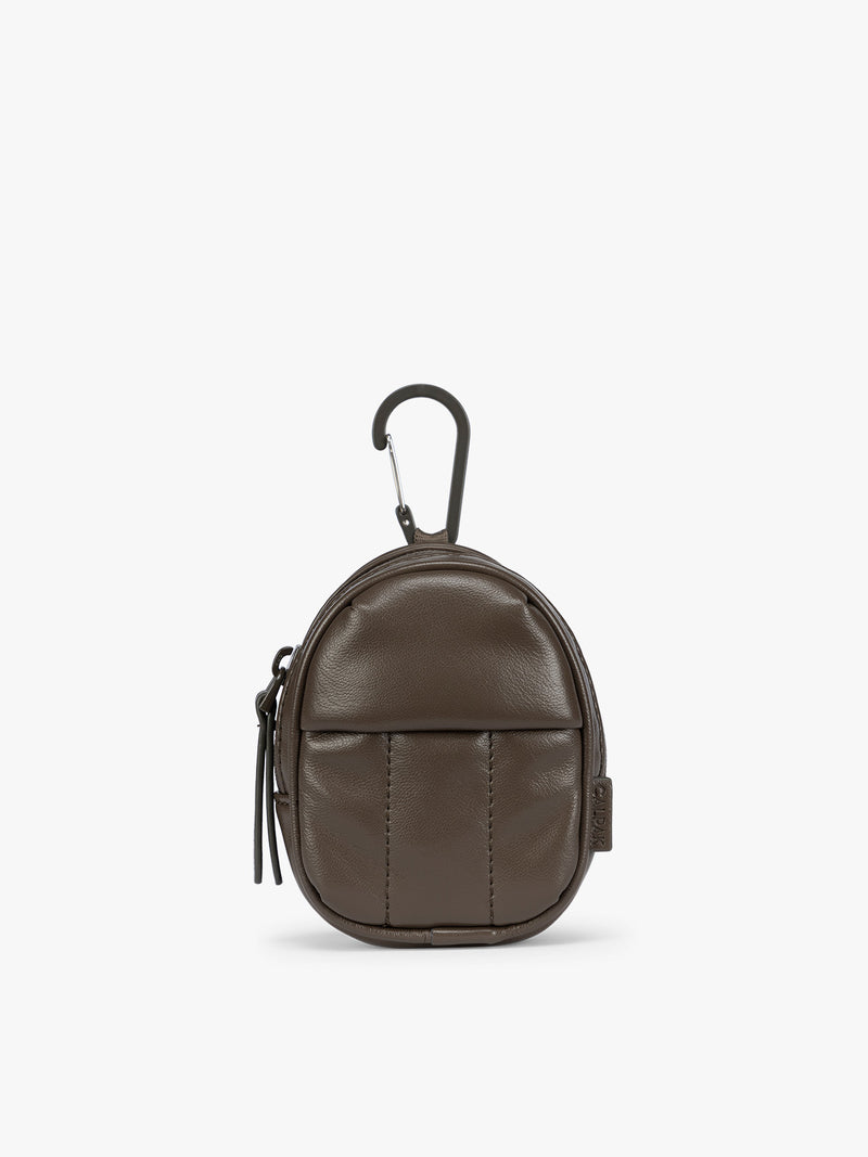 A small brown Mushroom CALPAK Luka Backpack Zip Bag Charm leather backpack keychain with a top carabiner and zipper pull, shown on a plain white background