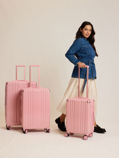 CALPAK pc Ambeur Luggage Set featuring the Ambeur Carry-On Luggage, Ambeur Medium Luggage and Ambeur Large Luggage in metallic pink Blossom with pink wheels;  LAM3000-BLOSSOM view 2