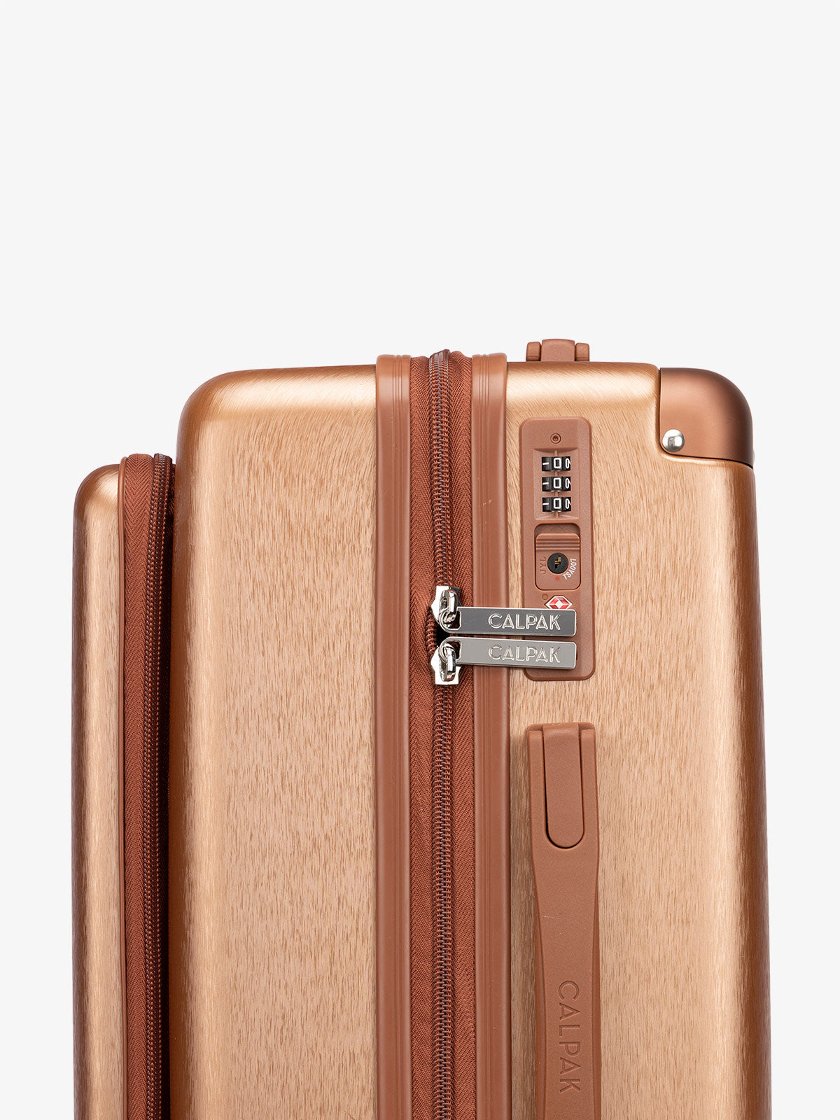 Close up shot of built-in TSA lock on copper CALPAK Front Pocket Ambeur hardside carry-on luggage; LAM1020-FP-COPPER
