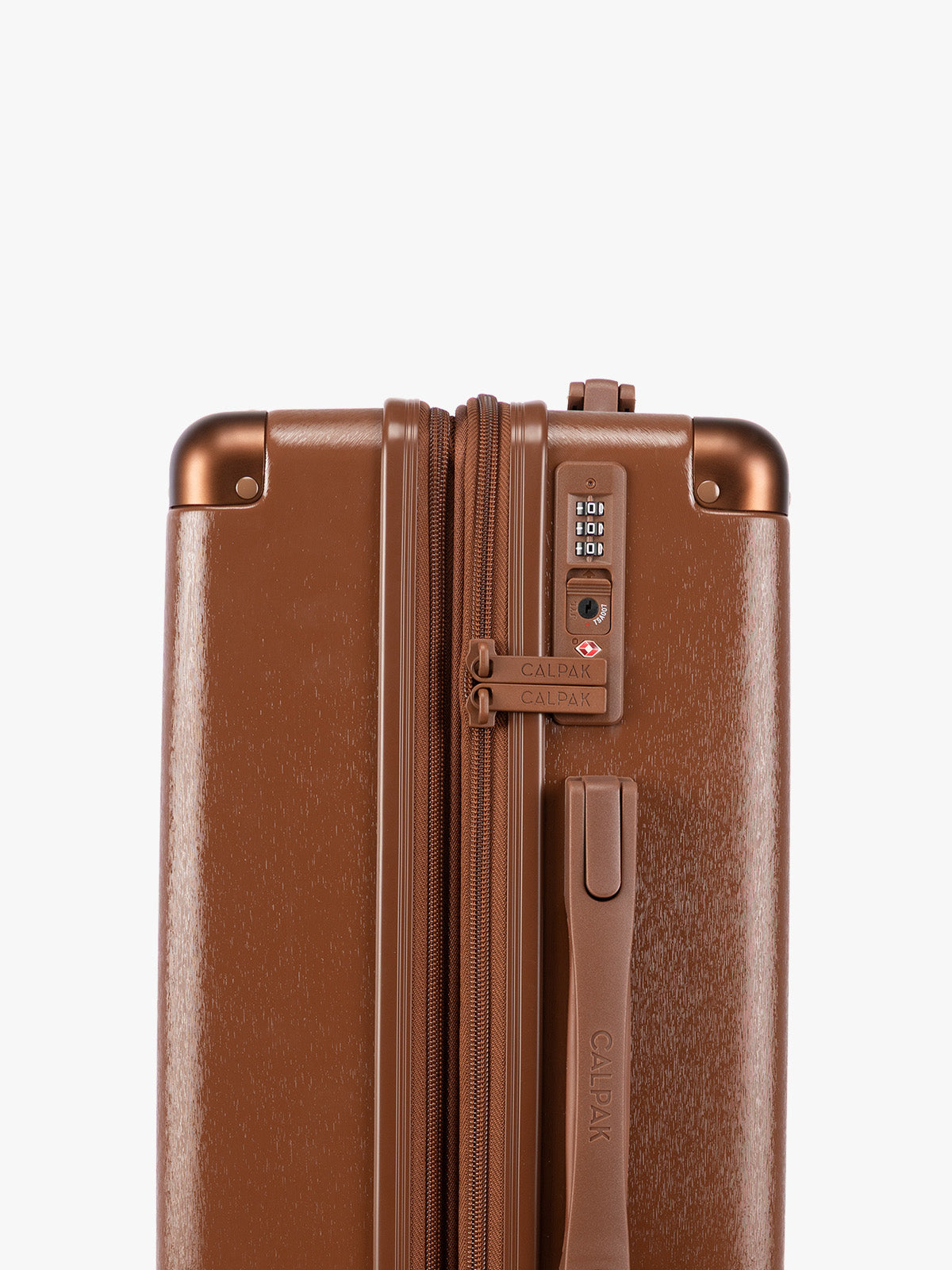 TSA lock closeup of the CALPAK Ambeur Medium Luggage in light Honey Brown with vertical ribbed detailing and an extended telescoping handle, shown from the front against a plain white background; LAM1024-HONEY-BROWN
