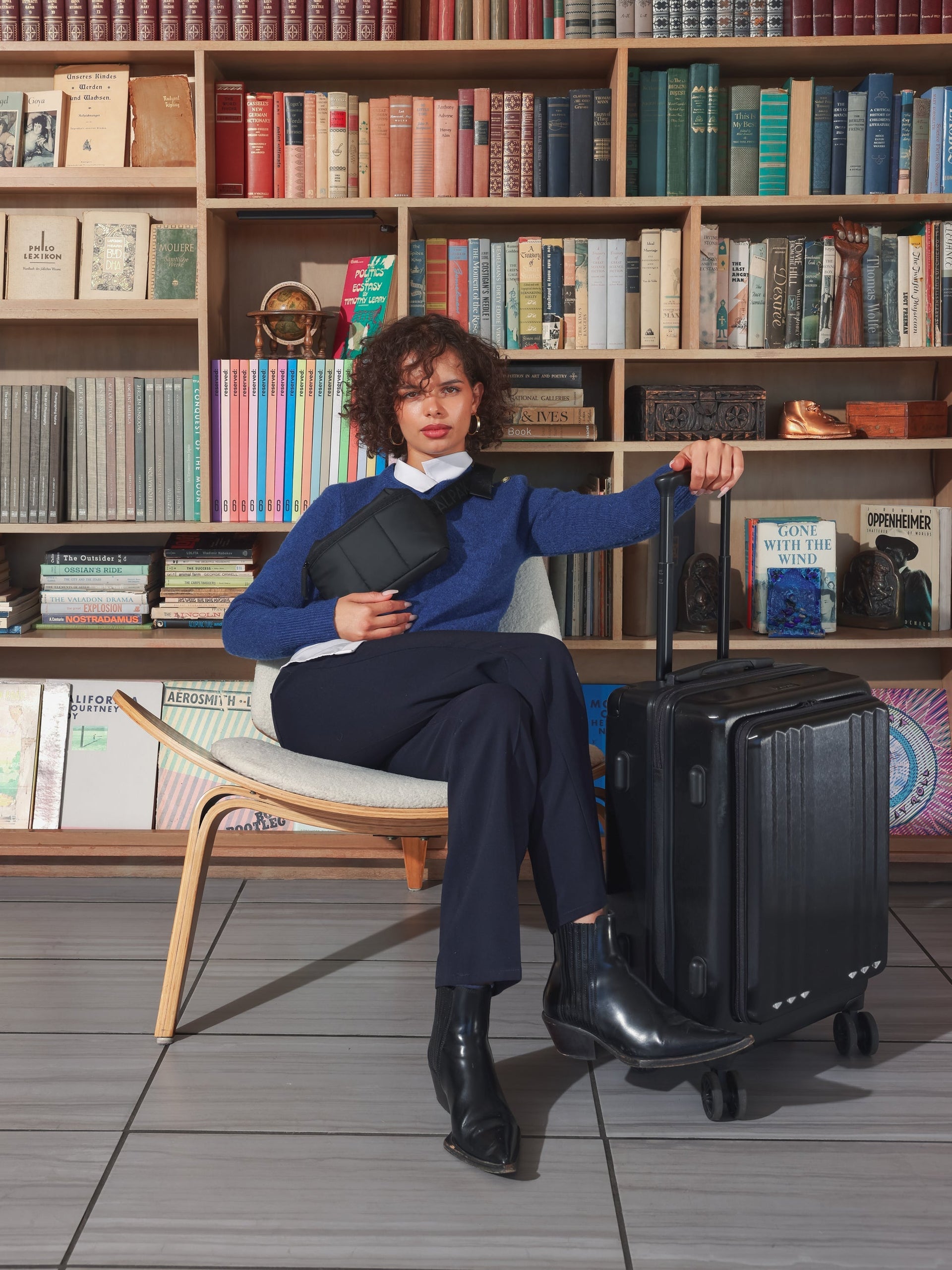 Model with CALPAK Ambeur carry on luggage with front pocket for laptop in black; LAM1020-FP-BLACK