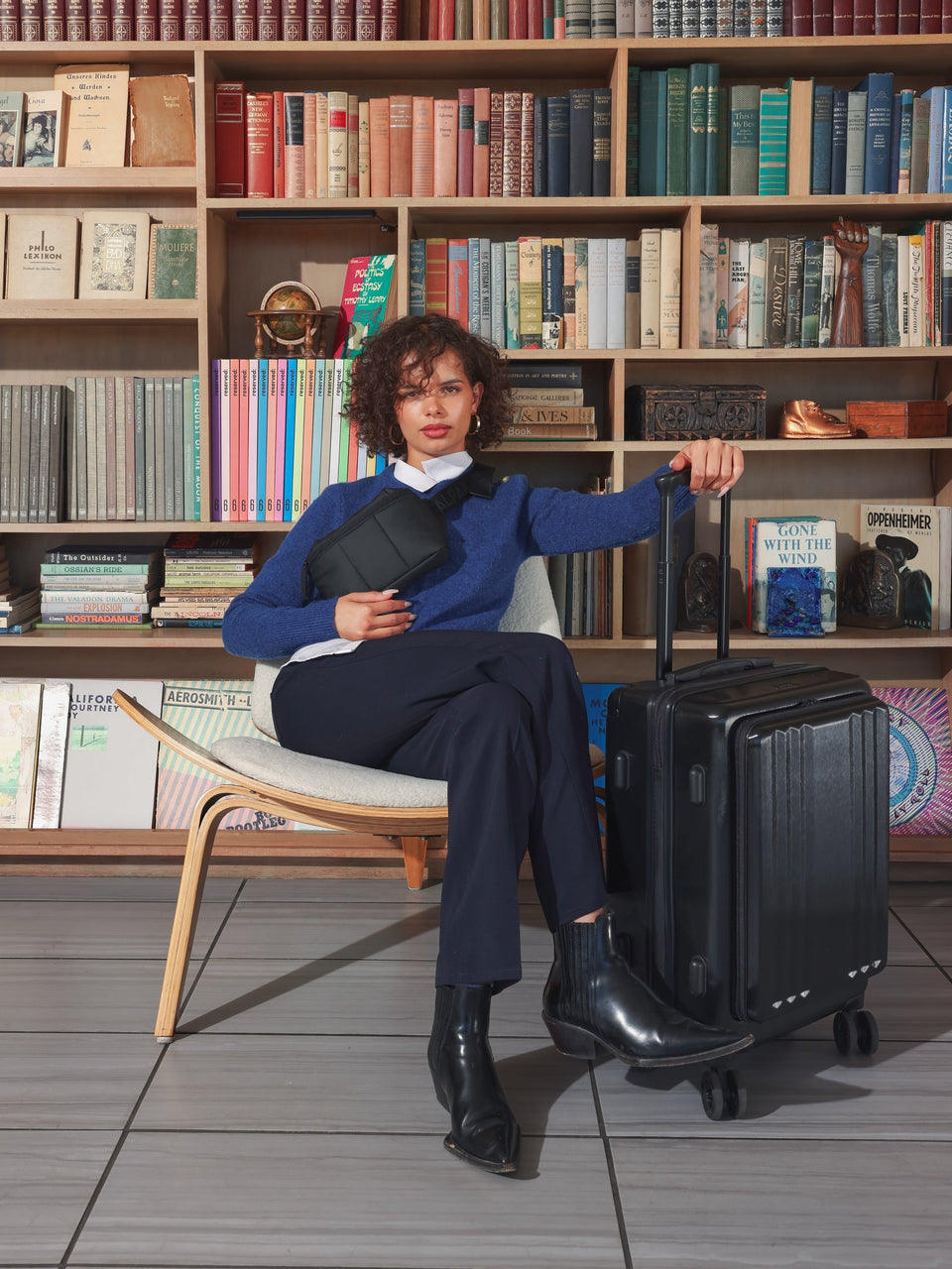 Model with CALPAK Ambeur carry on luggage with front pocket for laptop in black; LAM1020-FP-BLACK