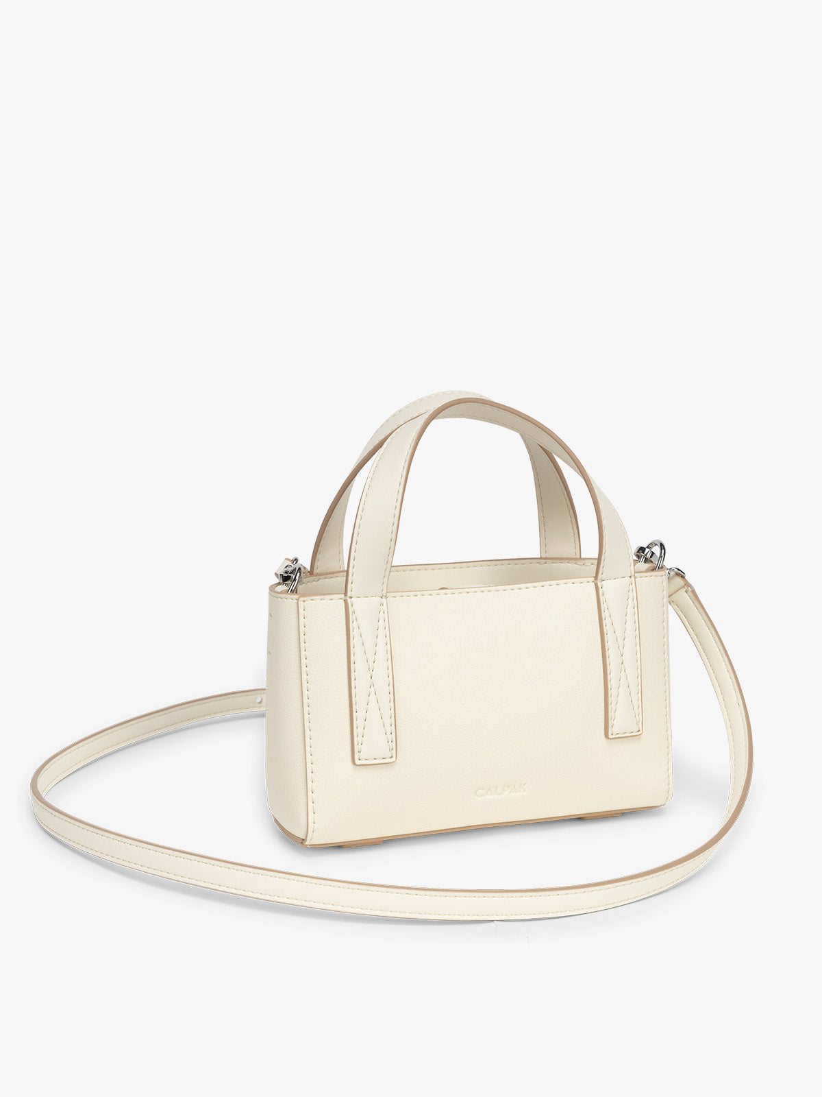 Side view of CALPAK Haven Mini Crossbody Bag in beige Buttercream; AMC2501-BUTTERCREAM