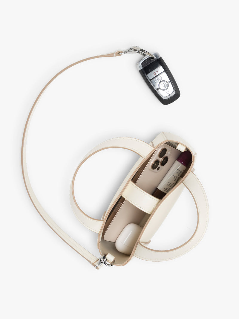 Opened view of CALPAK Haven Mini Crossbody Bag in beige Buttercream