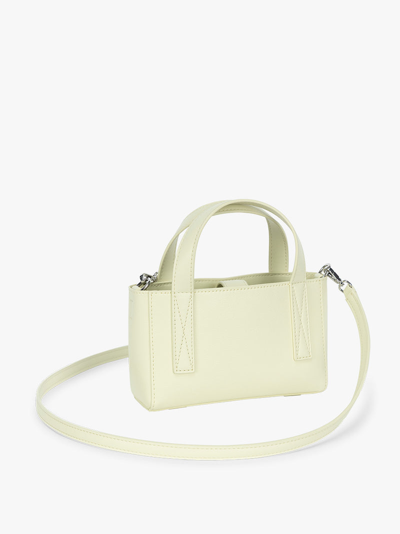 Side view of CALPAK Haven Mini Crossbody Bag in light green Celadon