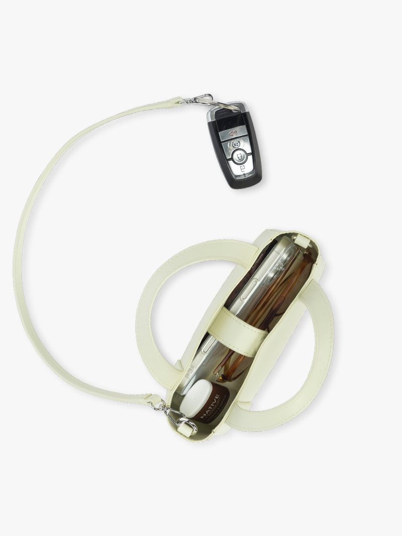 Opened view of CALPAK Haven Mini Crossbody Bag in light green Celadon