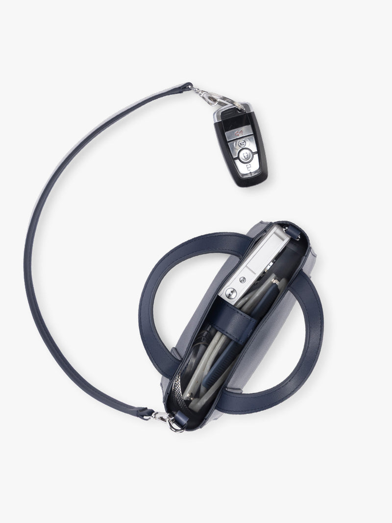 Opened view of CALPAK Haven Mini Crossbody Bag in dark blue Navy